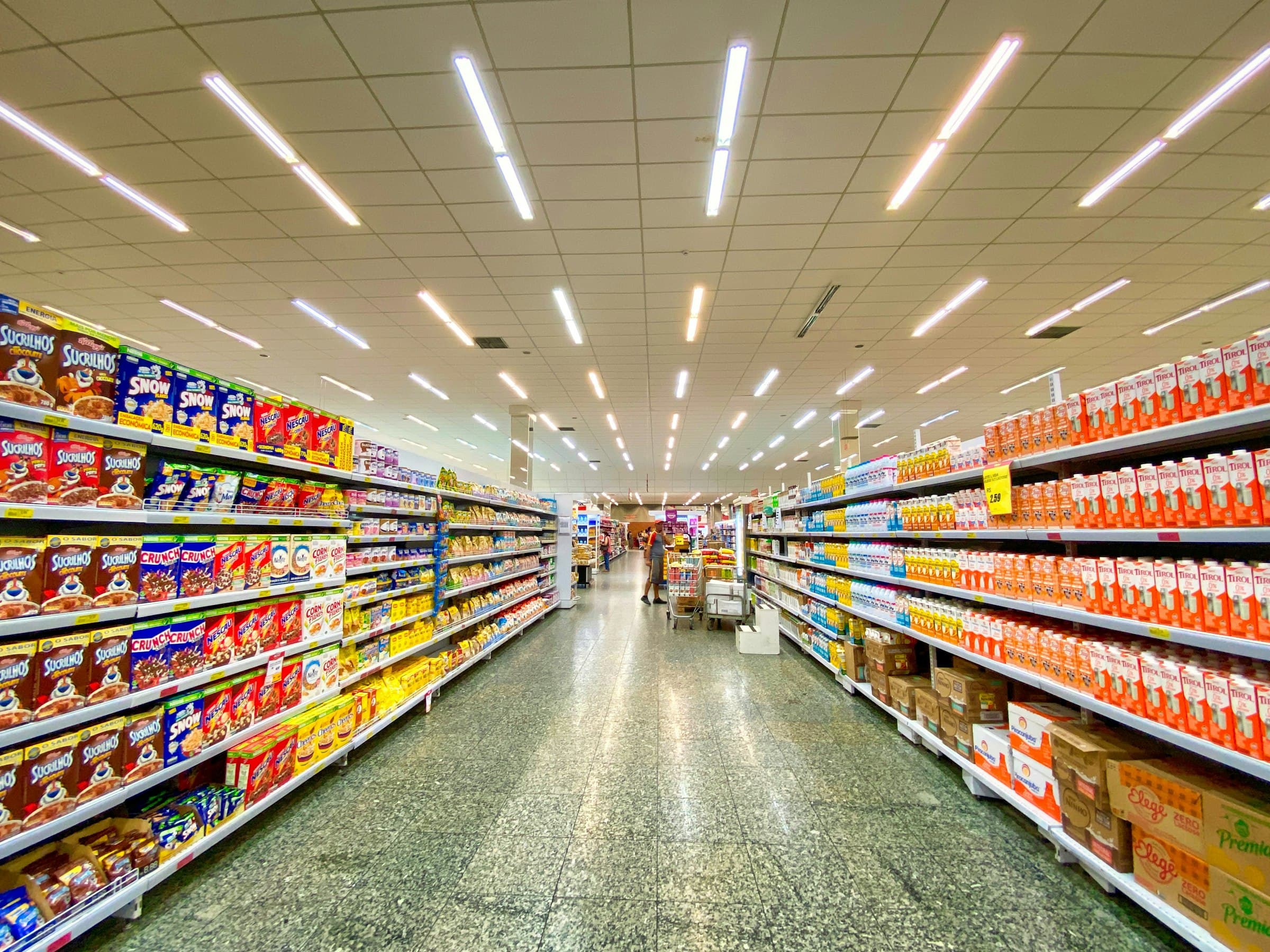 A supermarket aisle with well-stocked shelves